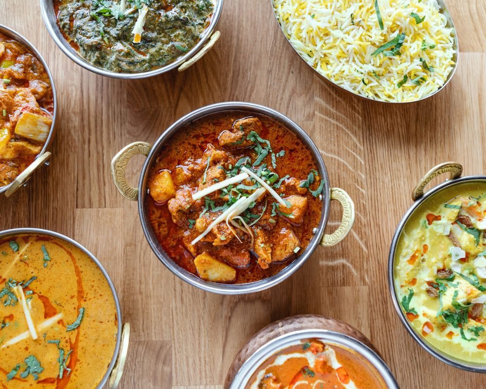 Composition of different indian street food on wooden background