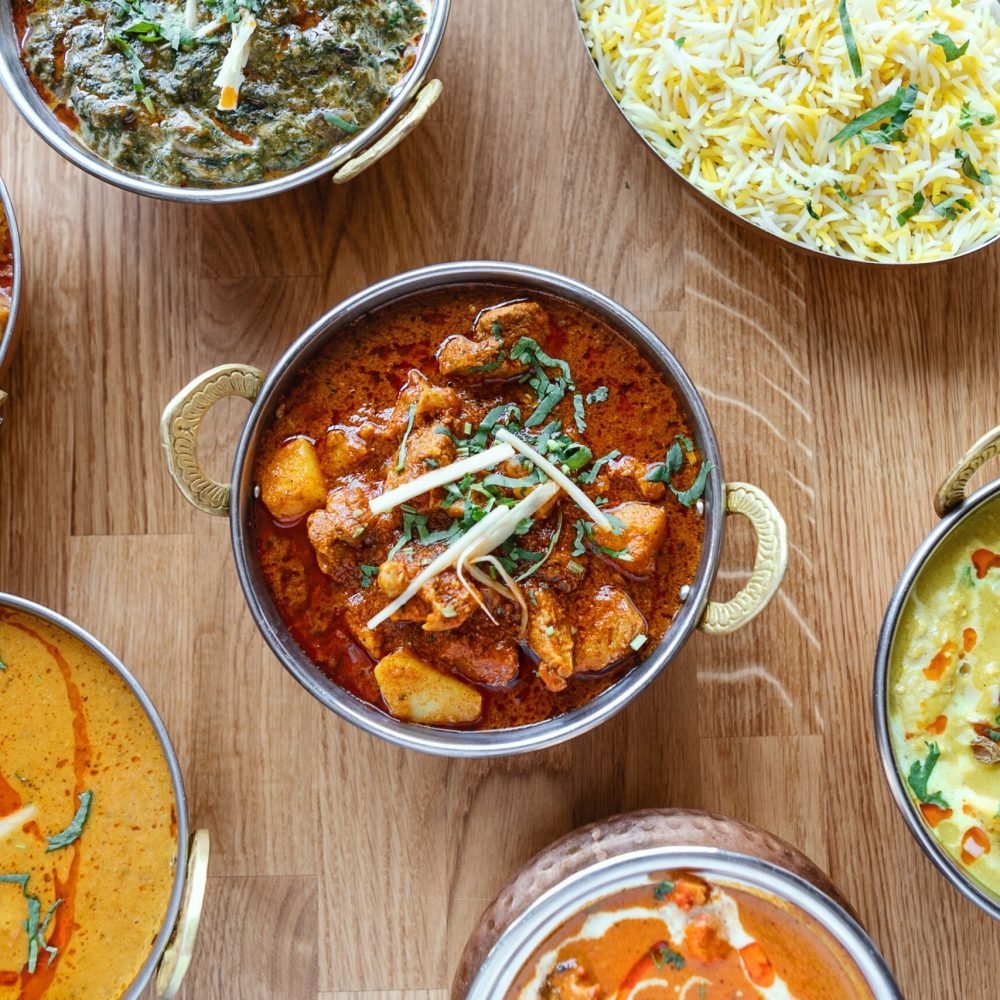 Composition of different indian street food on wooden background